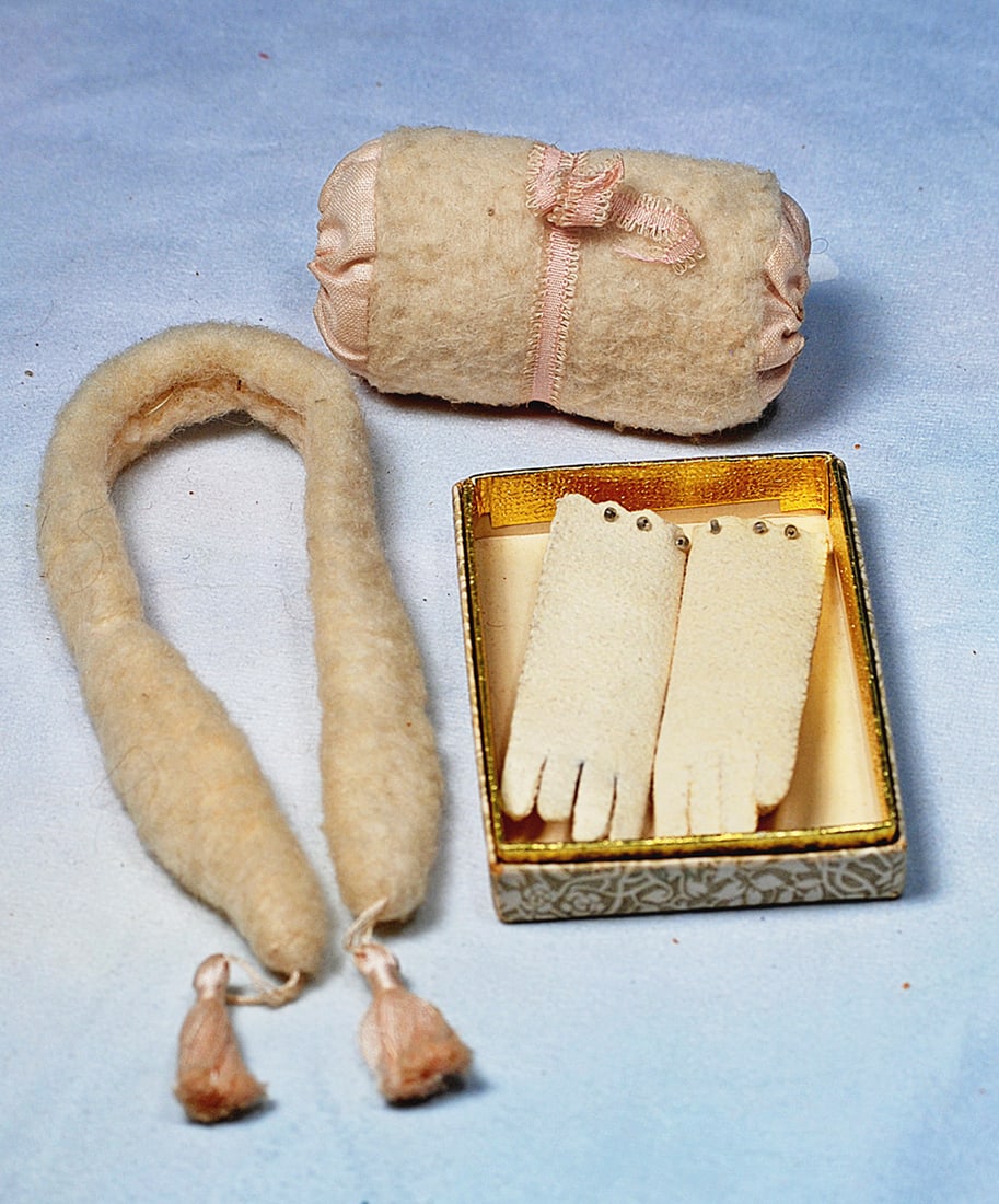 PAIR OF WHITE KIDSKIN GLOVES, FAUX FUR MUFF AND STOLE: 3” L. pair of soft white kidskin gloves with scalloped edging and tiny bead trim, in original box; white faux fur 11” stole with pink tassels and matching 3” W. muff with pink silk
