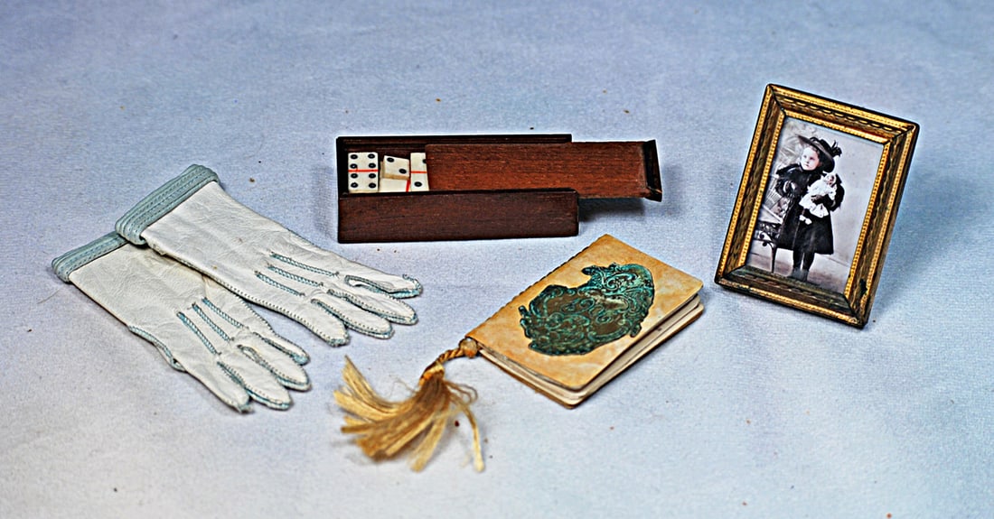 GROUP OF DOLL ACCESSORIES: 3” pair of white kidskin gloves with pale blue stitching and trim; 2” booklet containing 1906 calendars, embossed cover with silk tassel; 2 ½” L. set of miniature dominoes in