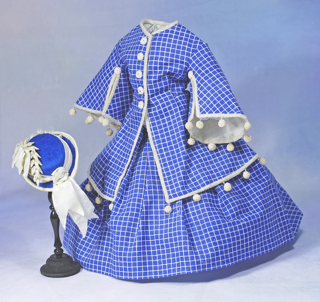 FASHION ENSEMBLE FOR POUPEE: Sized for 17” poupee. Comprised of a fine blue tunic with narrow white lines and blue squares in a window pane effect, features pagoda style sleeves which are slashed to above the elbow,