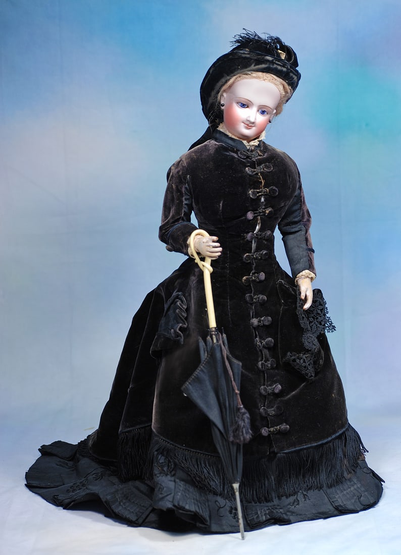 FRENCH BISQUE POUPEE WITH WOODEN ARMS BY LEON CASIMIR BRU: 19”. Marks: Depose (forehead) K (back of head). Bisque swivel head on bisque shoulderplate, blue paperweight eyes, painted lashes, eyeliner feathered brows, pierced ears, original