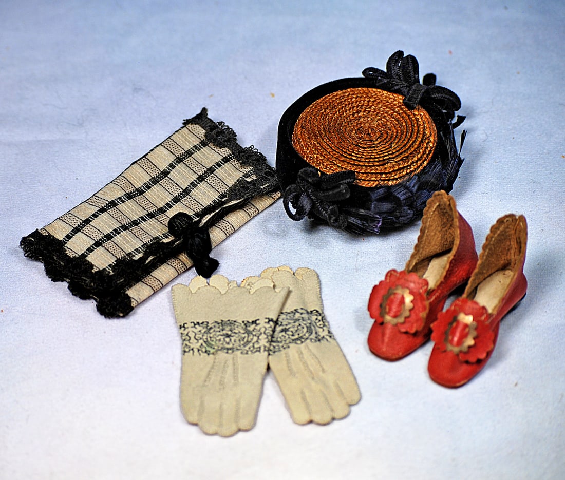 DOLL ACCESSORIES FOR POUPEE: Pair of 1 ½” L. rose leather doll slippers with scalloped edging and bows, gilt buckle, wooden heels; woven straw artist-made bonnet with black velvet band and bows front and back; pair of