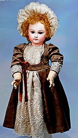 RARE FRENCH BISQUE BEBE, MODEL 10X, BY EMILE JUMEAU: 26”. Marks: 10 X. Bisque socket head, brown paperweight eyes, painted lashes, eyeliner, feathered and brushstroked brows, rose-blushed eye shadow, closed mouth, shaded and accented l