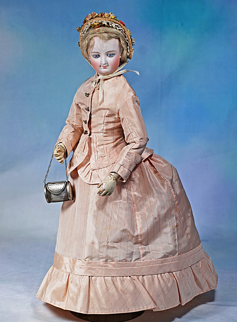 SMILING FRENCH BISQUE POUPEE BY LEON CASIMIR BRU WITH ARTICULATED WOODEN BODY: 16”. Marks: P. Bisque swivel head on bisque shoulderplate, blue paperweight almond-shaped eyes, painted lashes, eyeliner, feathered brows, pierced ears, closed mouth in slight smiling expr