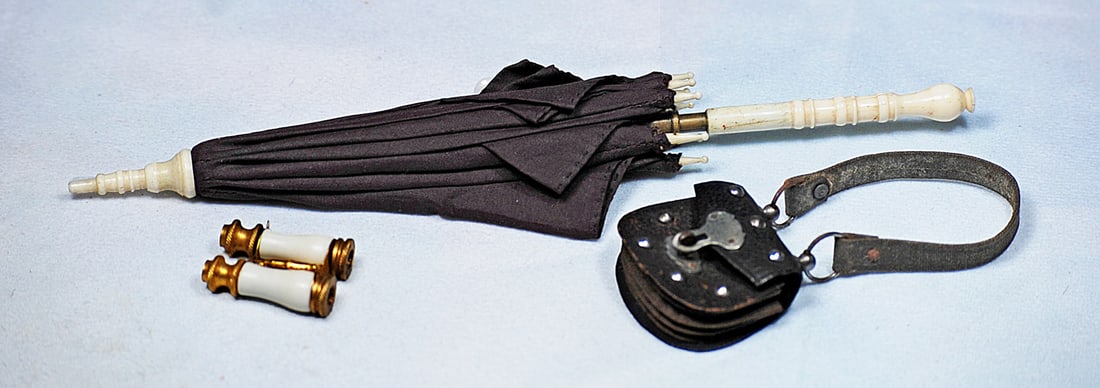 ANTIQUE SILK PARASOL, LEATHER PURSE, AND OPERA GLASSES: 8” Brown silk parasol with carved bone handle, tip and points, metal fittings; 1 ½” brown leather purse with leather strap, and 1” pair of gilt-trimmed opera glasses.