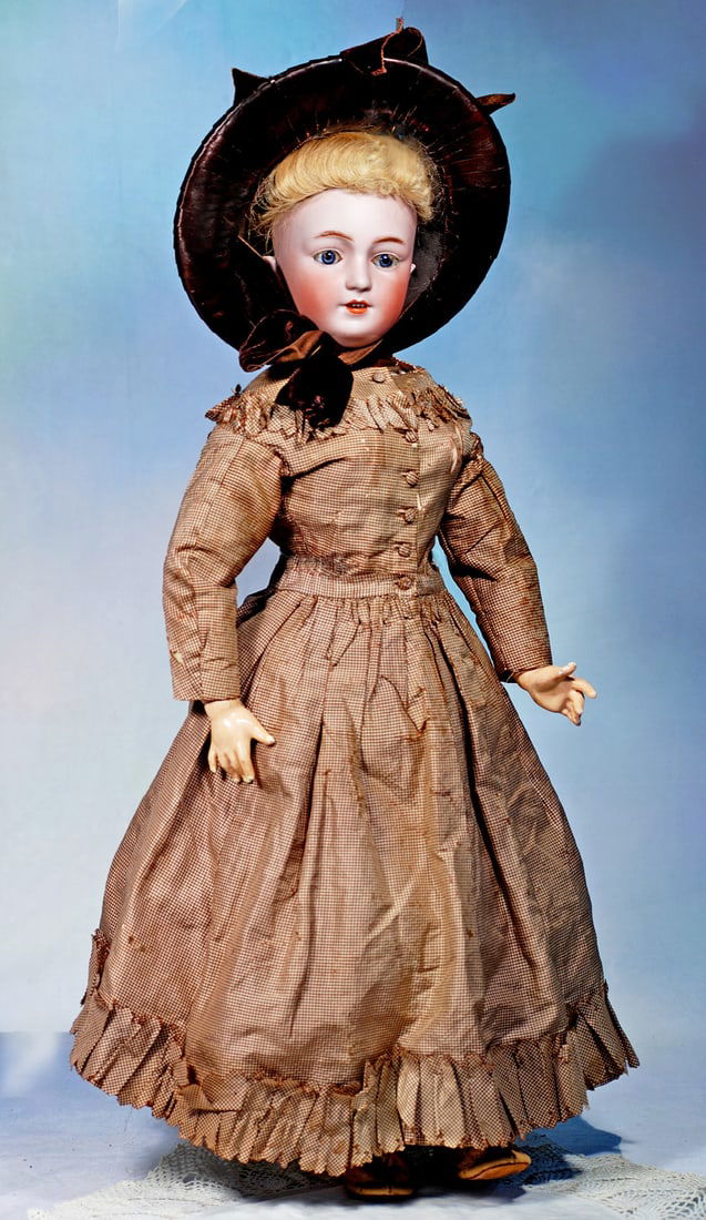 GERMAN BISQUE LADY DOLL IN ORIGINAL GOWN, ATTRIBUTED TO SIMON AND HALBIG:  24”. Marks: 10. Bisque socket head, stationary blue glass eyes, painted lashes, eyeliner, molded and feathered brows, pierced ears, open mouth, shaded and accented lips,