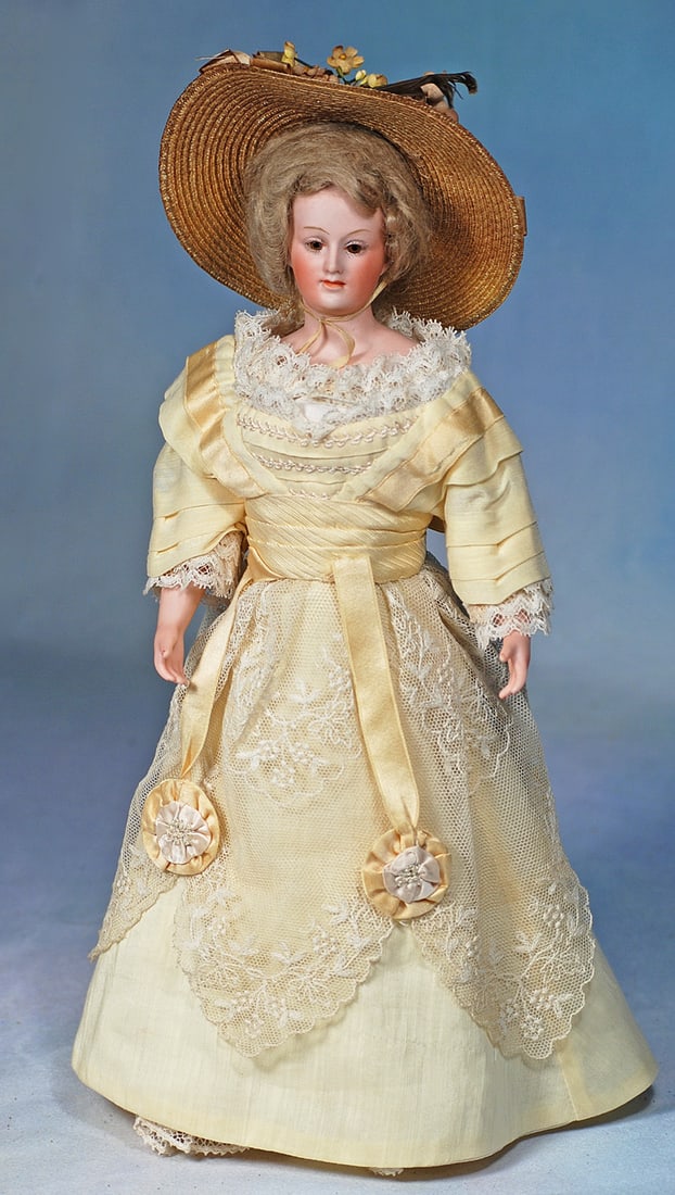 ACCESSORIES FOR POUPEE: 3 1/4”. French feather muff constructed with alternate bands of soft light gray feathers and dark lavender feathers, silk lining, in cylindrical box with shop label of “Galeries