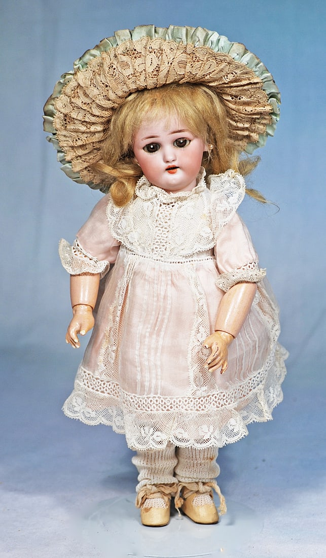 GERMAN BISQUE SIMON AND HALBIG 1078 WITH BEBE VRAI MODELE LABELLED BODY: 11”. Marks: 1078 Germany Halbig S & H (head); Bebe Vrai Modele Fabrication Jumeau (body label). Bisque socket head, brown sleep eyes, painted lower lashes and applied upper lashes, f