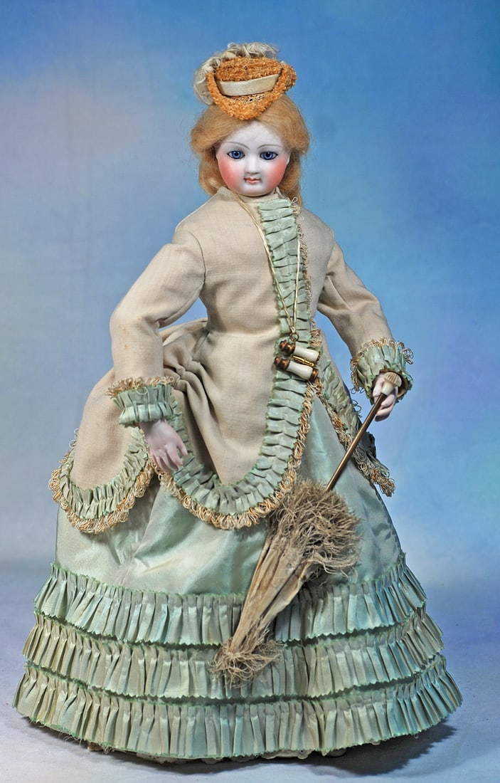 FRENCH BISQUE POUPEE BY BARROIS WITH DISTINCTIVE BODY ATTRIBUTED TO TERRENE: 17”. Marks: E. 4 B.(front shoulderplate). Bisque swivel head on bisque shoulderplate, large almond-shaped blue paperweight eyes, painted lashes, dark eyeliner, feathered brows, pierc