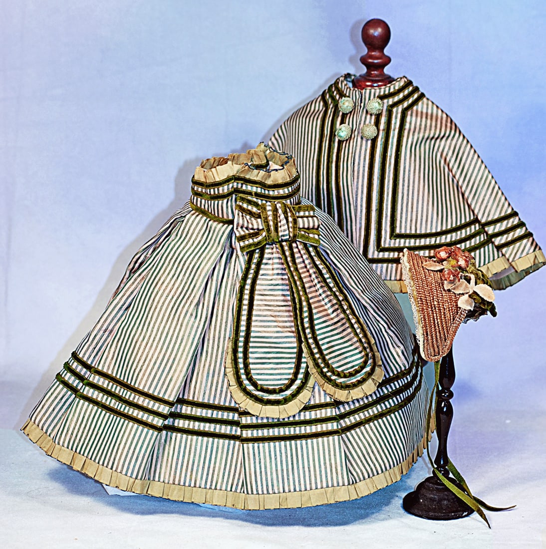 STRIPED SILK ENSEMBLE FOR POUPEE: Features a palest pink and warm green silk striped skirt with high waist band and box pleats all trimmed in narrow bands of green velvet ribbon with rounded lappets all edged in green velvet and