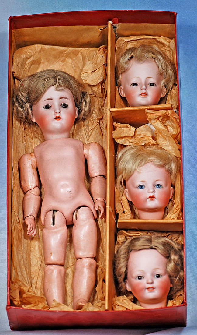 GERMAN BISQUE MULTI-HEAD “WUNDERKIND” DOLL SET BY KESTNER: 11”. Marks: 136 2/0. Bisque socket head, brown sleep eyes, painted lashes, feathered brows, open mouth, accented lips, upper teeth, brown mohair wig in coiled side braids,