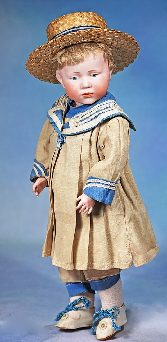 GERMAN BISQUE POUTY CHARACTER, 101, BY KAMMER AND REINHARDT: 15”. Marks: K * R 101. Bisque socket head, painted features, downward glancing blue eyes, deeply sculpted eye lids, upper eyeliner, tapered brows, closed mouth with full lips in pout
