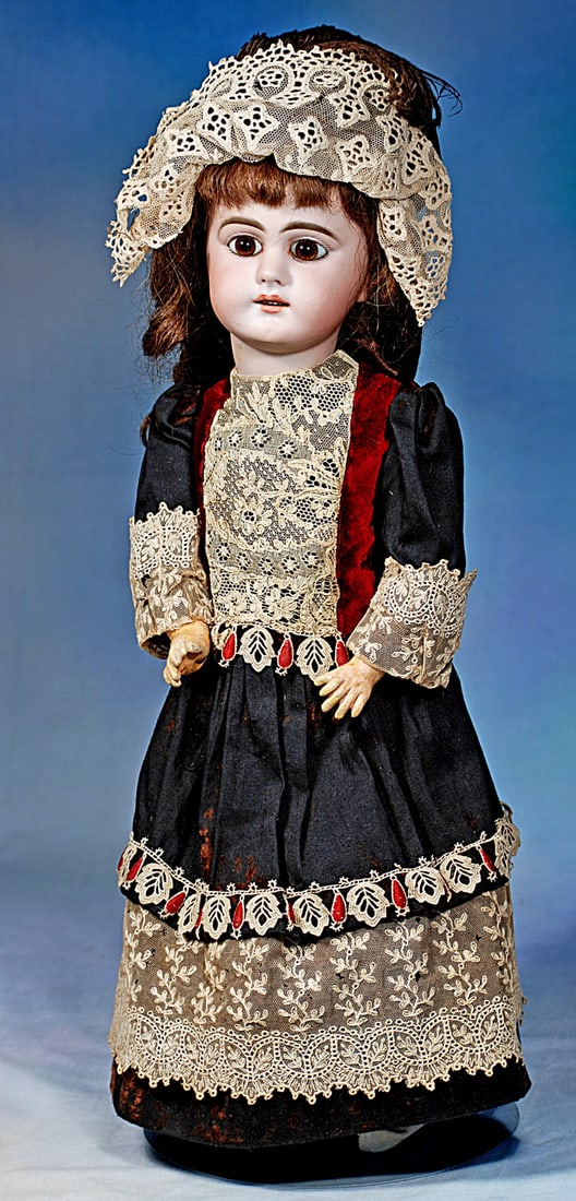 GERMAN BISQUE CHILD, 749, BY SIMON AND HALBIG: 19”. Marks: 749 Dep 8. Bisque socket head, set brown paperweight eyes, painted lashes, eyeliner, feathered brows, pierced ears, open mouth, shaded lips, upper teeth, original brown human h
