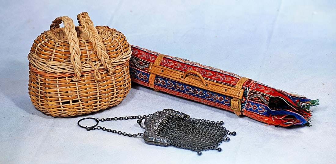 ASSORTED DOLL ACCESSORIES. FOR POUPEE:  Includes: 4” natural woven wicker market basket with hinged top and twin handles; 7 ½” L. rolled woolen carriage wrap with fringed edges and leather straps; 3 ½” mesh