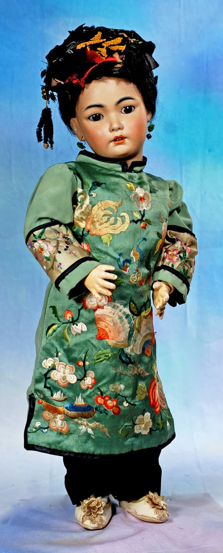 GERMAN BISQUE ASIAN CHILD, 1329, BY SIMON AND HALBIG: 20”. Marks: 1329 Germany Halbig. Amber-tinted bisque socket head, brown sleep eyes, black feathered brows and lashes, open mouth, accented lips, upper teeth, pierced ears, original