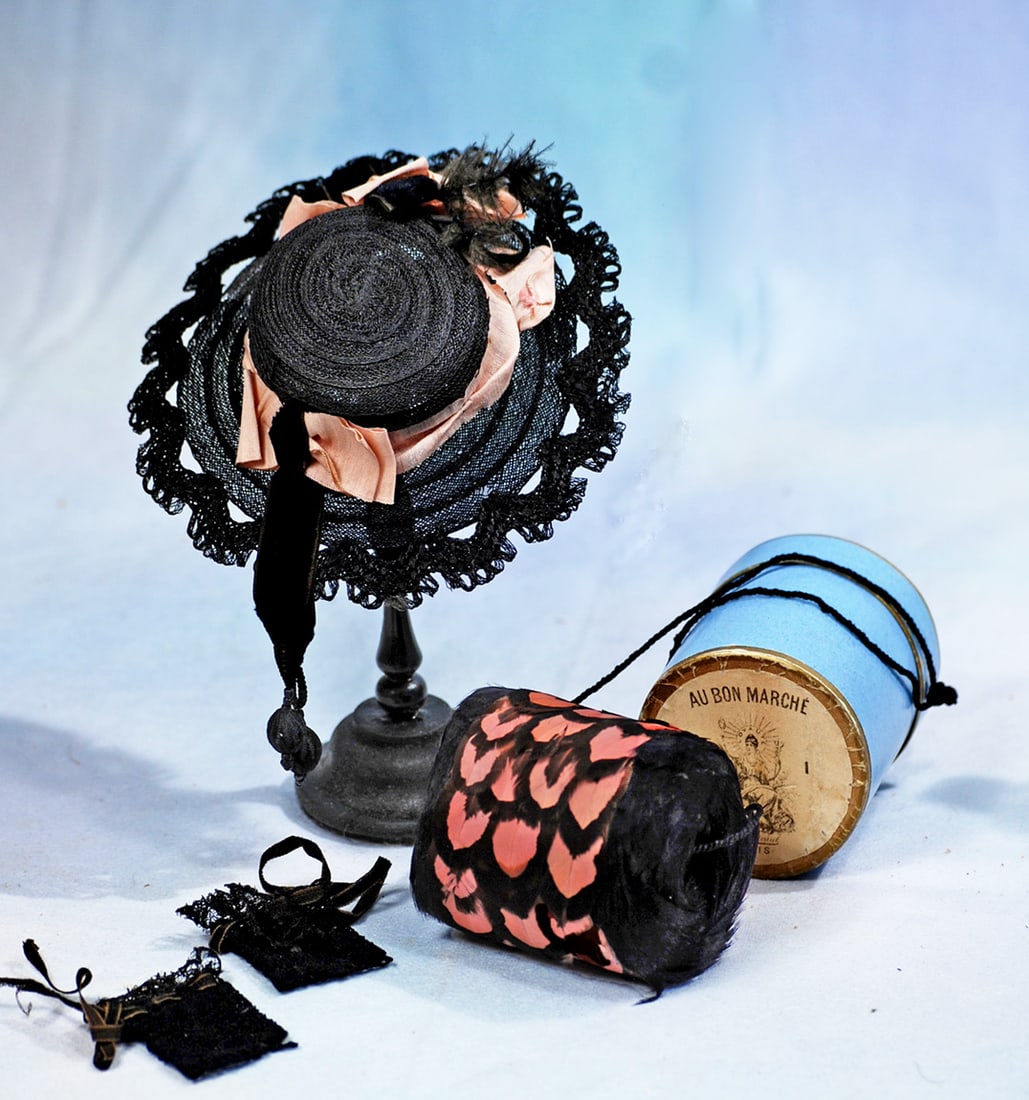 DOLL BONNET, MUFF, AND HALF MITTS: Fancy woven black straw bonnet adorned with pink silk and black velvet ribbons and sparkling black jets; for 6” to 7” head circumference; 2 ¾” black and pink feather fur muff
