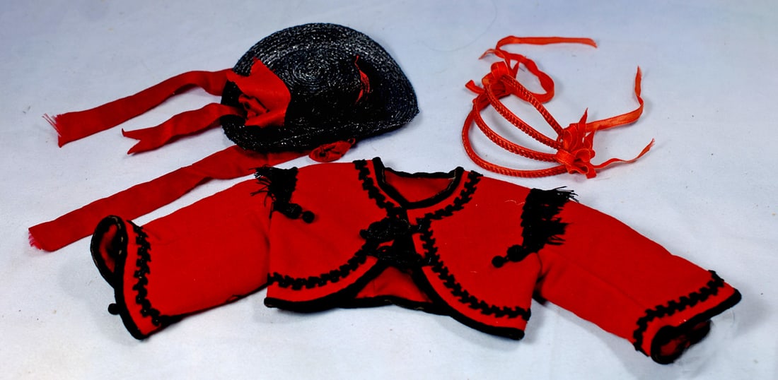 RED WOOL JACKET, STRAW BONNET AND WIRED HEADBAND: Red woolen Figaro jacket with black ornate braid all around, narrow velvet edging, black fringe detail at shoulders, 5:” shoulder width, 4” L.; fanciful black straw bonnet with shaped