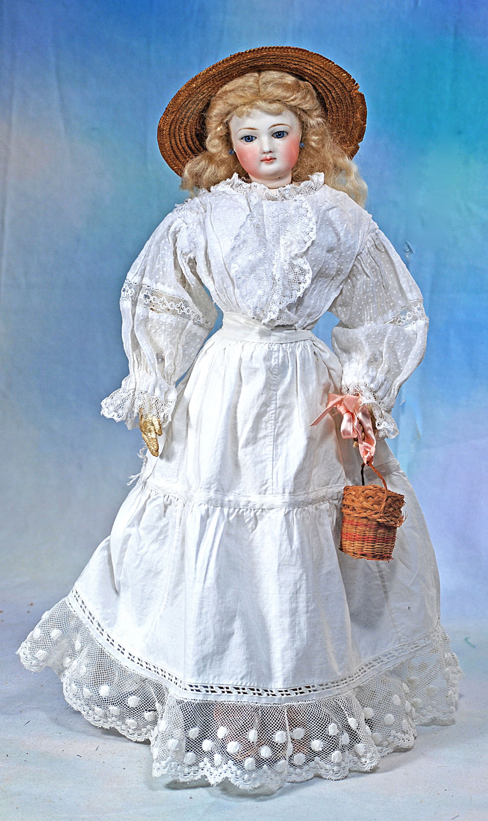 FRENCH BISQUE POUPEE: 17”. Marks: None. Bisque swivel head on bisque shoulderplate, almond-shaped blue paperweight eyes, painted lashes, eyeliner, feathered brows, pierced ears, closed mouth, shaded and a