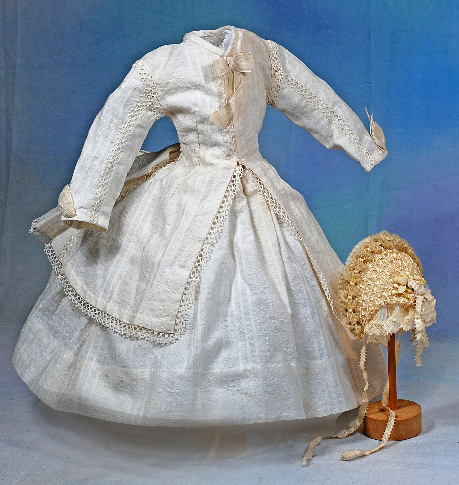 LOVELY ENSEMBLE FOR FRENCH POUPEE.: 247. LOVELY ENSEMBLE FOR FRENCH POUPEE. Includes a gown of fine white cotton patterned with woven stripes and dainty flower design made up in a fitted jacket having bows of white ribbon accenting