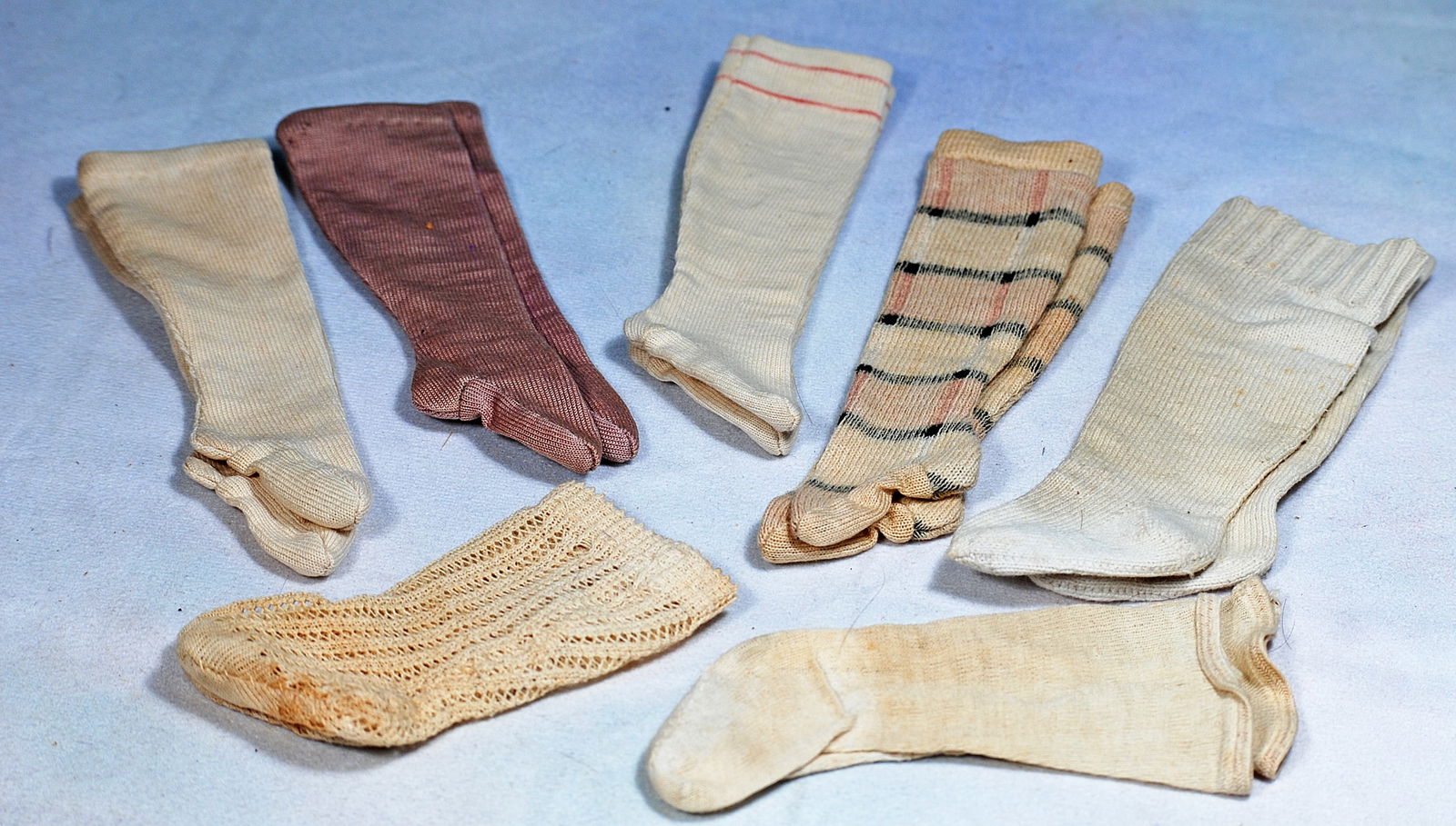 SEVEN PAIRS OF DOLL STOCKINGS. .: 255. SEVEN PAIRS OF DOLL STOCKINGS. Assorted colors, sizes 4” to 6” length.