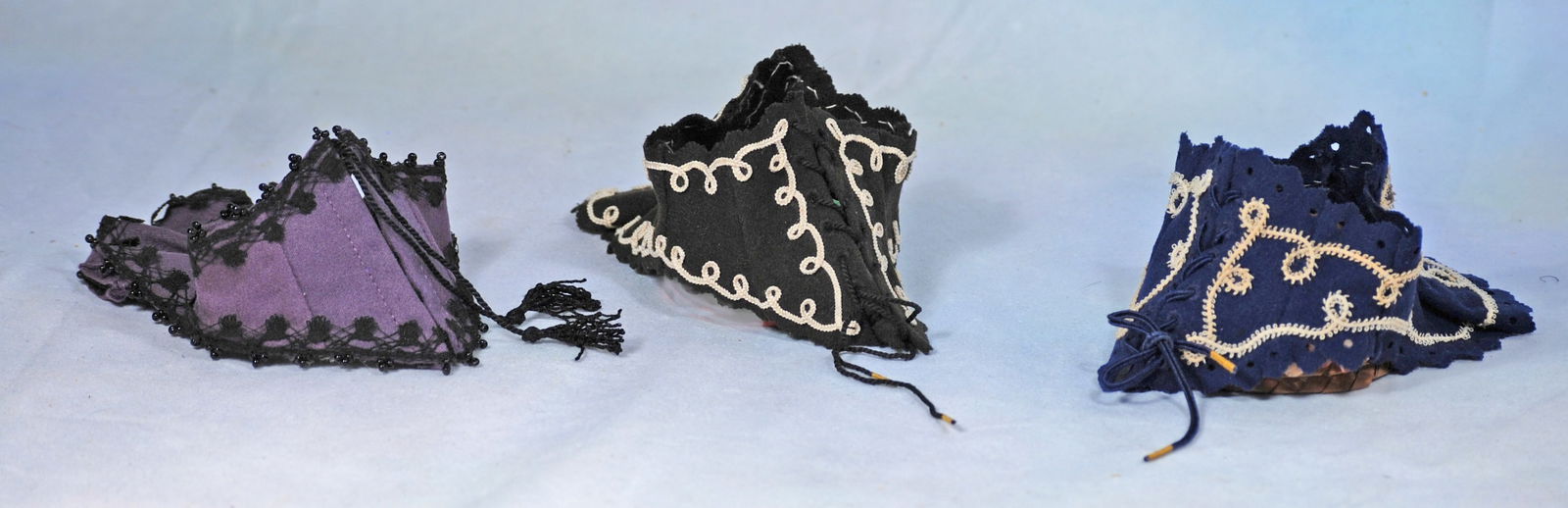 THREE DOLL CORSELETS IN VICTORIAN-ERA STYLE.: 267. THREE DOLL CORSELETS IN VICTORIAN-ERA STYLE. Designed to be worn on the outside and shaped to fit snug to the body, extending slightly below the waist with points in front and/or back, front