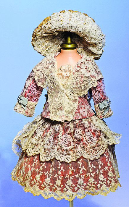 FANCY TWO-PIECE LACE-OVER-VELVET FROCK WITH MATCHING: FANCY TWO-PIECE LACE-OVER-VELVET FROCK WITH MATCHING BONNET. 4” shoulder width, 11” overall length. Ivory shadow lace over red velvet fabric, fitted jack with wide collar and lapels, two-tiered ga