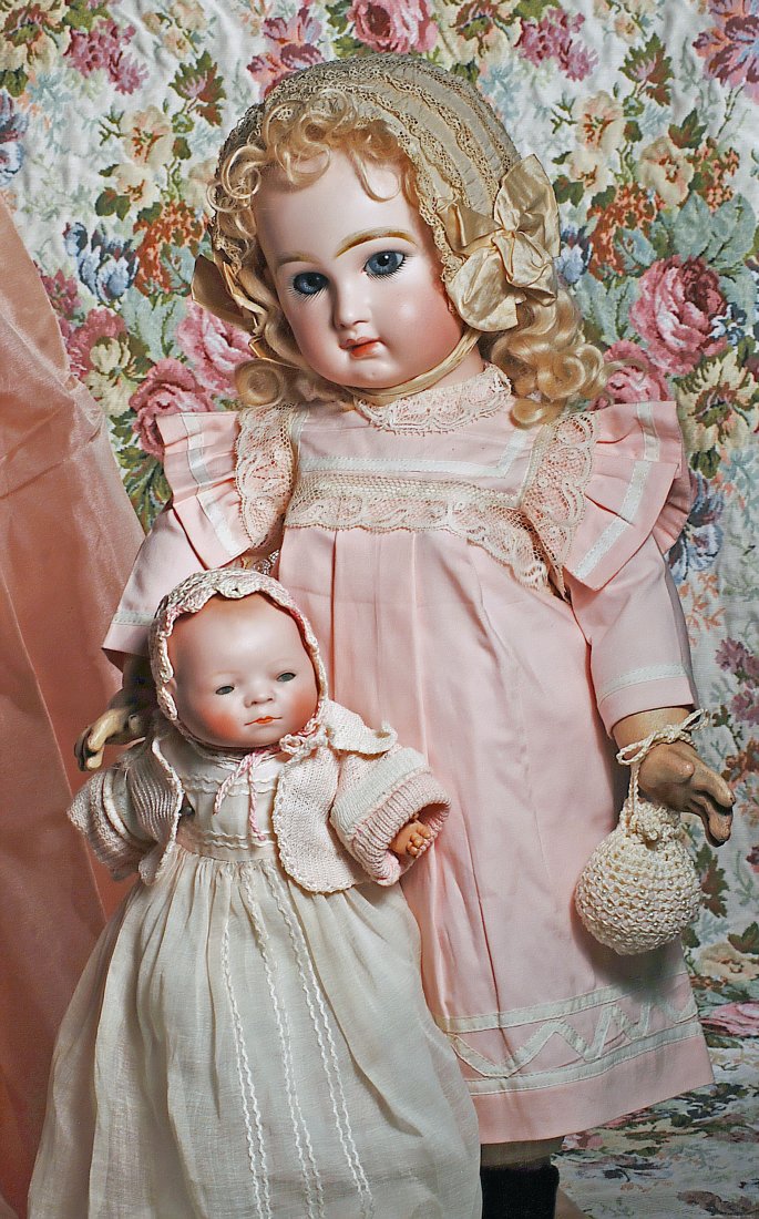 PRETTY BLUE-EYED FRENCH BEBE JUMEAU. Marks: Depose: PRETTY BLUE-EYED FRENCH BEBE JUMEAU. Marks: Depose Tete Jumeau Bte. Sgdg 10. 22 ½”. Bisque socket head, sparkling blue paperweight eyes, dark eyeliner, lush painted curly lashes, feathered brows, p