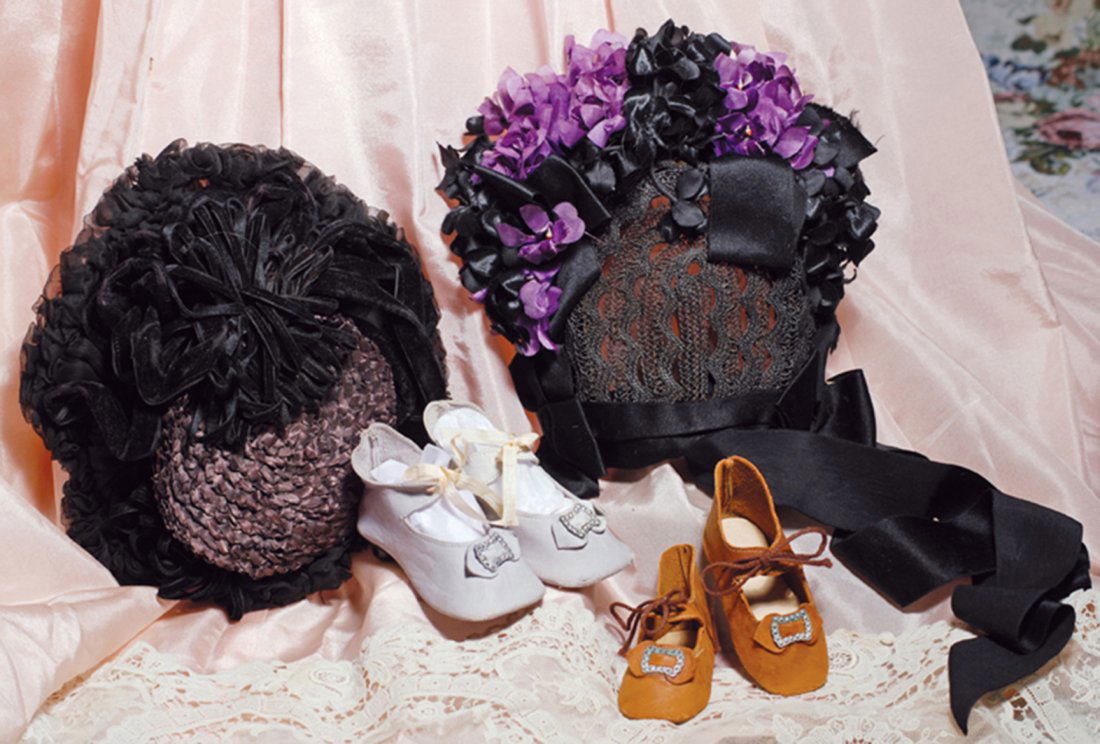 TWO FANCY STRAW & ORGANZA SHIRRED DOLL BONNETS. Each: TWO FANCY STRAW & ORGANZA SHIRRED DOLL BONNETS. Each has woven straw back with tall wired brim covered in tightly shirred black organza; one decorated with black velvet clustered ribbons and one accen