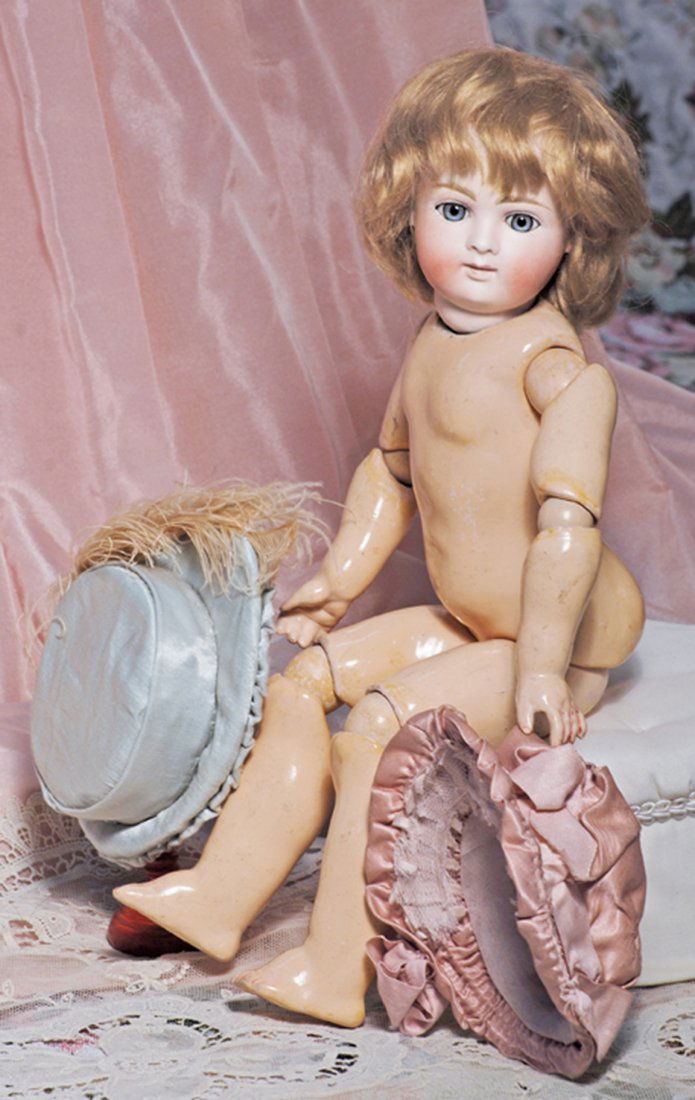 TWO FINE SILK-SATIN DOLL BONNETS. 2 ¼” inside cap: TWO FINE SILK-SATIN DOLL BONNETS. 2 ¼” inside cap width. Pale blue bonnet with firm, flat-shaped back, shirred brim with lace overlay and lining, pale pink plume; Rose bonnet with full gathered bac