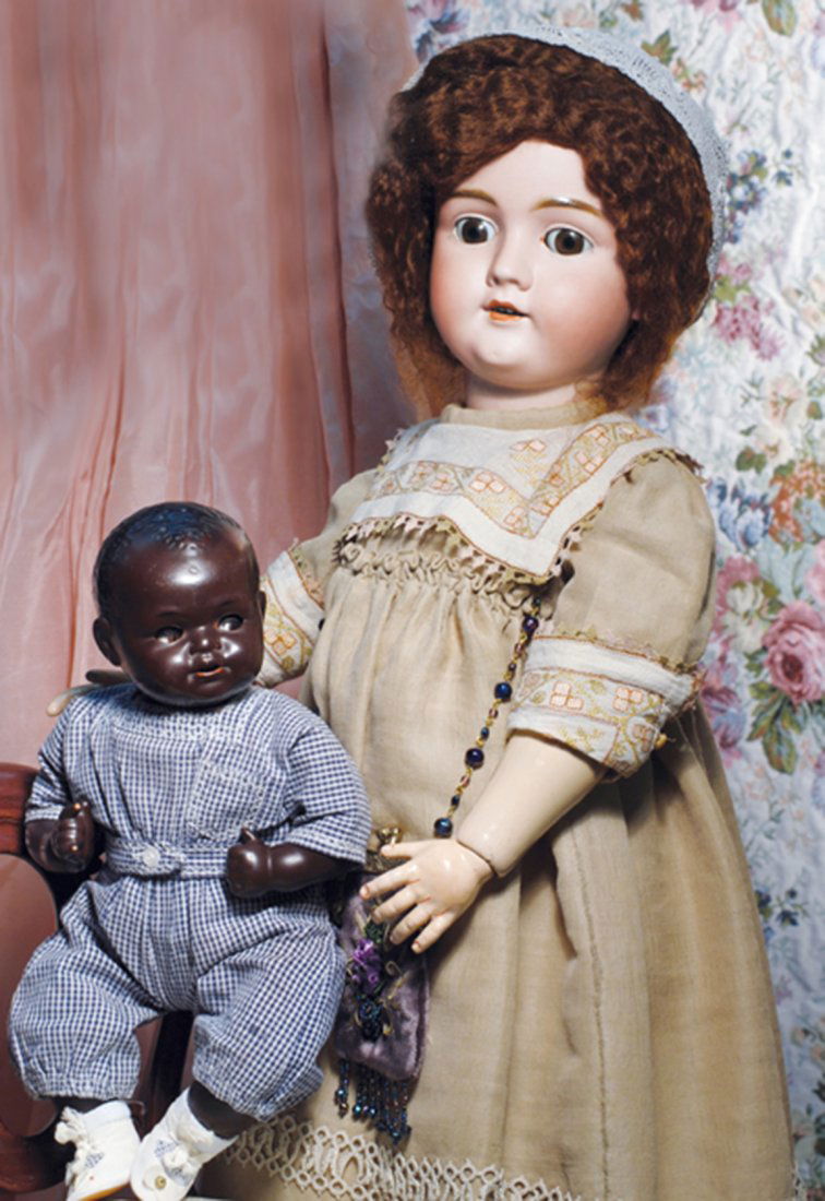 KAMMER & REINHARDT BLACK COMPLEXIONED CHARACTER BABY.: KAMMER & REINHARDT BLACK COMPLEXIONED CHARACTER BABY. Marks: K * R Germany. 14”. Solid domed socket head of earthenware with rich black complexion, molded short black curly hair, brown glass flirty