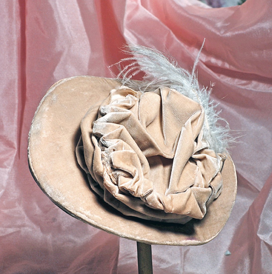 ANTIQUE VELVET BONNET WITH WIDE BRIM. 2 ½” inside cap: ANTIQUE VELVET BONNET WITH WIDE BRIM. 2 ½” inside cap width. Plush cream velvet made up in a hat with 3” deep stiffened brim, wire frame and full poufed and gathered back, velvet band, white feat