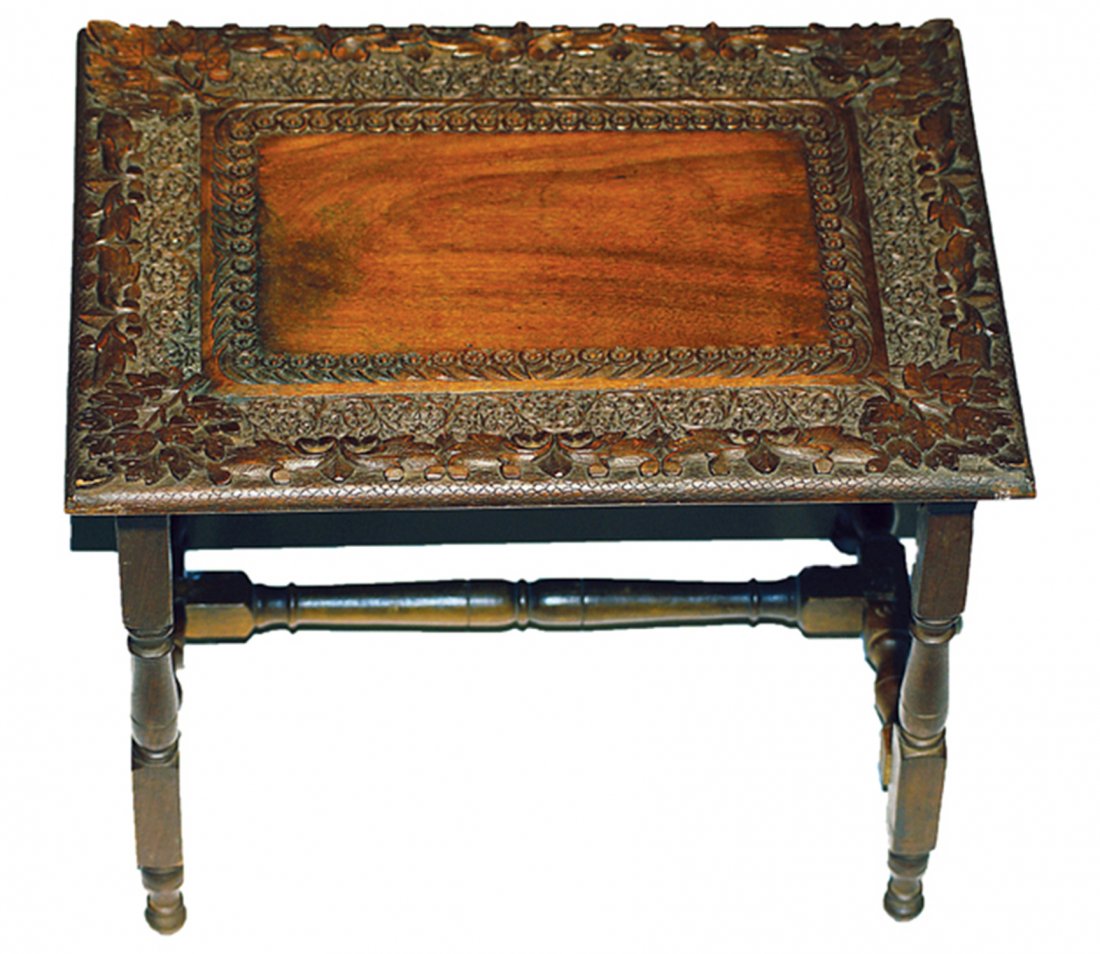 A RARE DOLL-SIZE BLACK FOREST CARVED TABLE FROM: A RARE DOLL-SIZE BLACK FOREST CARVED TABLE FROM GERMANY. 15 ½” W. x 11 ¼” D. x 12 ½” H. Circa 1875 dark walnut table with border of exquisite, intricately-carved detail, cross-braced turned l