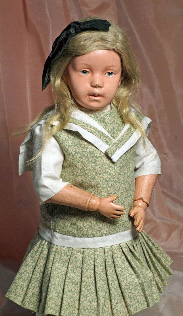 SCHOENHUT CARVED WOODEN CHARACTER DOLL. Marks:: SCHOENHUT CARVED WOODEN CHARACTER DOLL. Marks: Schoenhut incised mark on back. 14”. Carved wooden socket head on carved wooden spring-jointed body, painted features, blue intaglio eyes, lightly feat