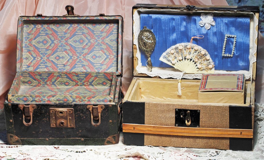 TWO ANTIQUE DOLL TRUNKS: 278. TWO ANTIQUE DOLL TRUNKS. (1) Black metal trunk with forest green patterned metal edging, paper-covered interior with lift-out tray, 10 ½” W. x 5 ½” H. (2) Wooden trunk with paper-covered ex