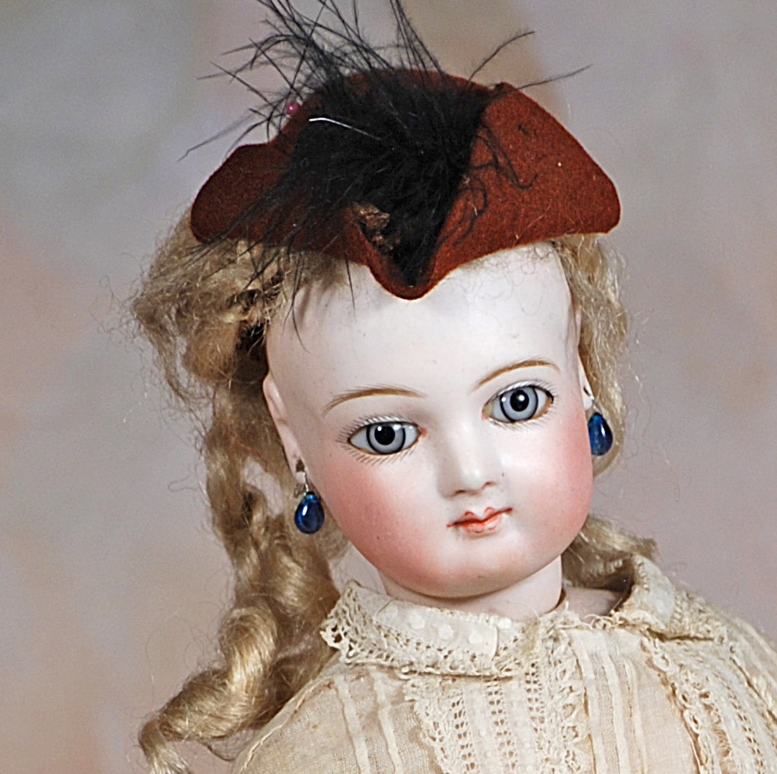 FRENCH BISQUE POUPEE BY JUMEAU: 54. FRENCH BISQUE POUPEE BY JUMEAU. 16”. Marks: None. Bisque swivel head on bisque shoulderplate, blue paperweight eyes, paimted lashes, eyeliner, multi-stroked brows, pierced ears, closed mouth