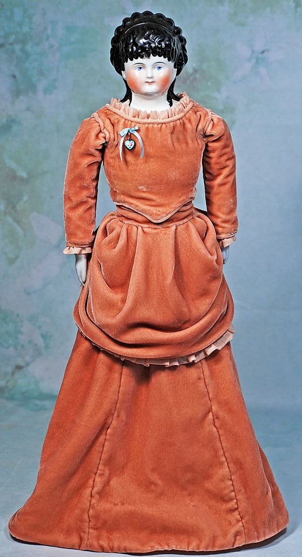 GERMAN PORCELAIN LADY WITH BLACK HAIR IN ELABORATE RINGLETS: 22”. Porcelain shoulderhead with plump face, black sculpted hair with elaborate tight ringlet curls onto the forehead with a wide black headband with tiers of arranged ringlet curls at the back 