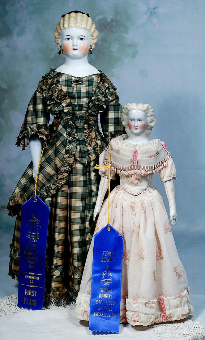 GERMAN PORCELAIN LADY WITH SCULPTED BLONDE CURLS AND ORIGINAL SILK GOWN: 21”. Marks: 10. Porcelain shoulderhead, sculpted blonde hair arranged in uniform horizontal curls accented at the crown with a black head band, pierced ears with green and gilt earrings, painted