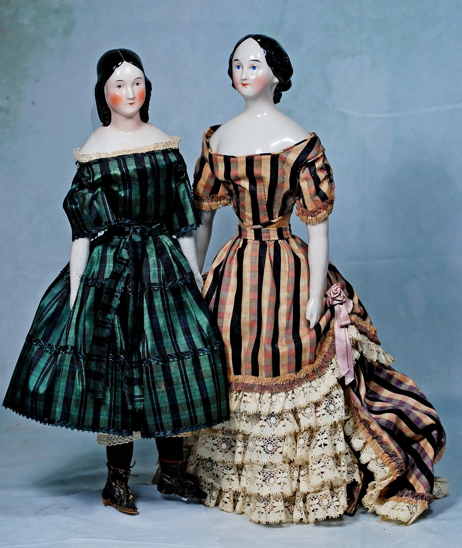 GERMAN PORCELAIN LADY WITH ARISTOCRATIC PRESENCE AND RARE COIFFURE: 16”. Porcelain shoulderhead with oval face, sculpted black hair with center-part and drawn in loose waves to back of head, forming an elaborate arrangement of looped braids and curls draping ove