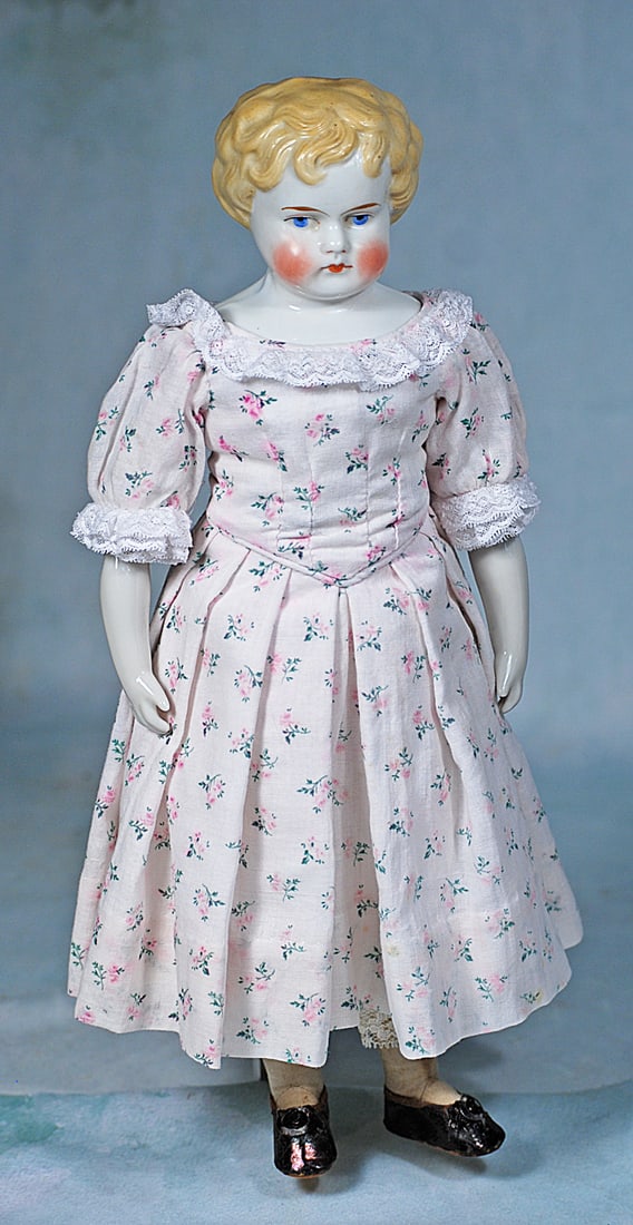 GERMAN PORCELAIN YOUNG LADY BY ALT, BECK AND GOTTSCHALK: 13 ½”. Marks: 889 # 5. Porcelain shoulderhead of young girl with sculpted blonde hair loosely arranged in tousled curls, painted features, blue eyes, red and black eyeliner tapered brown br