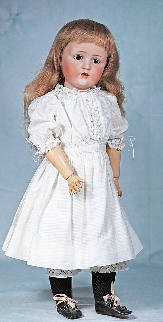 GERMAN BISQUE CHARACTER, JDK 249, BY KESTNER: 19 ½”. Marks: E. Made in Germany JDK 249. Bisque socket head, brown sleep eyes, painted lashes, eyeliner, feathered brows, open mouth, accented lips, upper teeth, light brown human hair wig