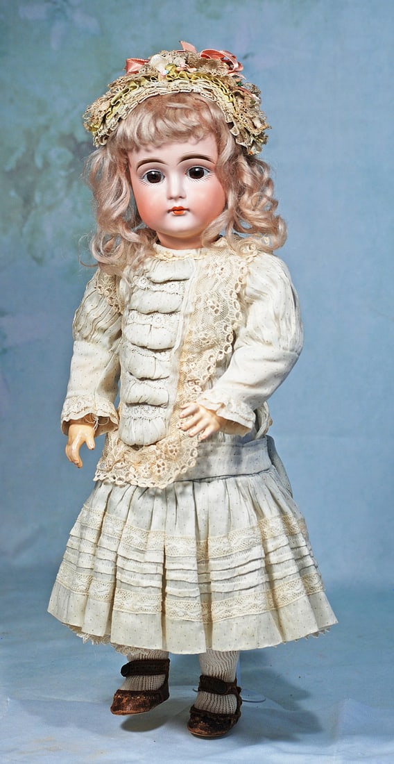 BEAUTIFUL GERMAN BISQUE CLOSED-MOUTH CHILD BY KESTNER: 18”. Marks: I made in Germany. Bisque socket head, brown sleep eyes, painted lashes, eyeliner, feathered and brushstroked brows, un-pierced ears, closed mouth, accented lips, original blonde moh