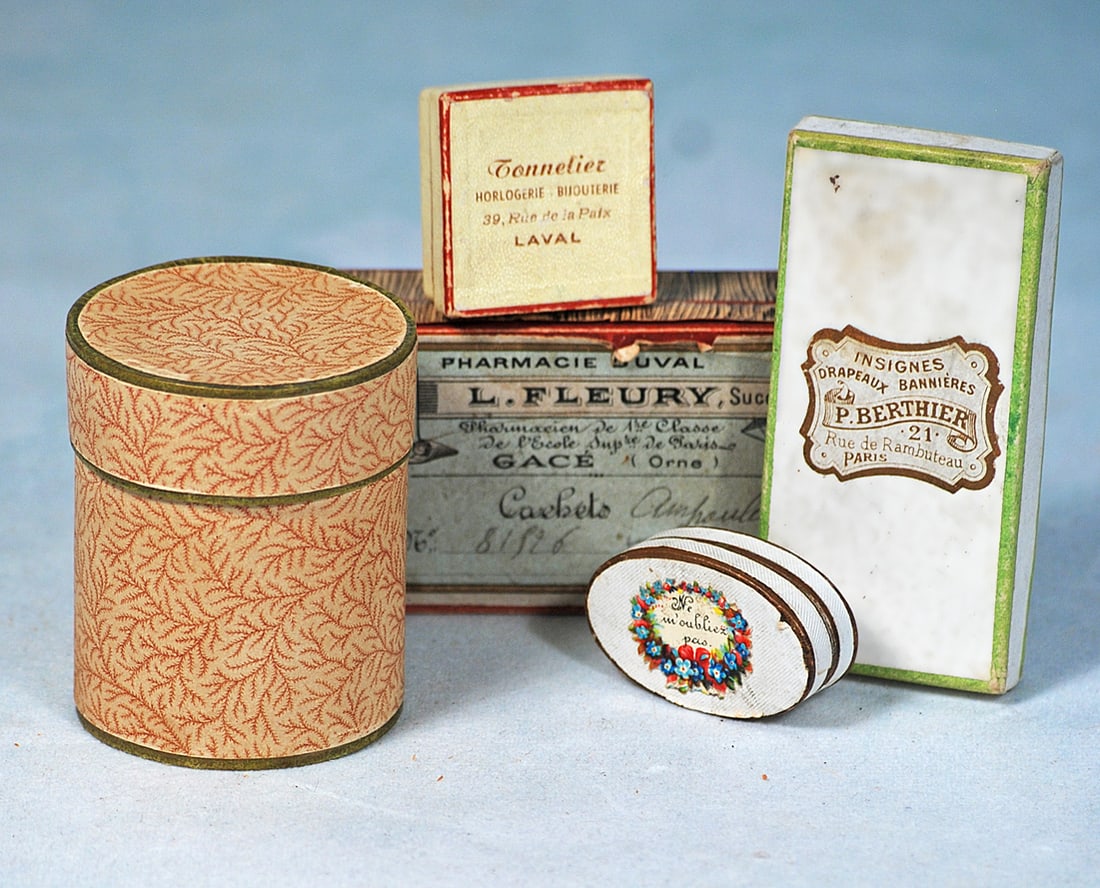 ASSORTMENT OF SMALL FRENCH NOVELTY BOXES AND HAT BOX: Four small cardboard boxes with lids, assorted shapes and French labels, 1 ¼” to 3 ¾"; plus, a 2 ½ H. Round cardboard box with lid which is marked “Au Printemps,