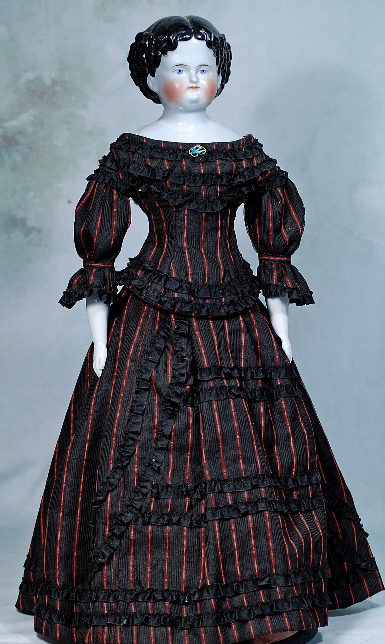 GERMAN PORCELAIN LADY IN ANTIQUE GOWN.: 268. GERMAN PORCELAIN LADY IN ANTIQUE GOWN. 23”. Porcelain shoulderhead, sculpted black hair with center-part and multiple rows of ringlet curls, fully-modeled ears, painted features, blue