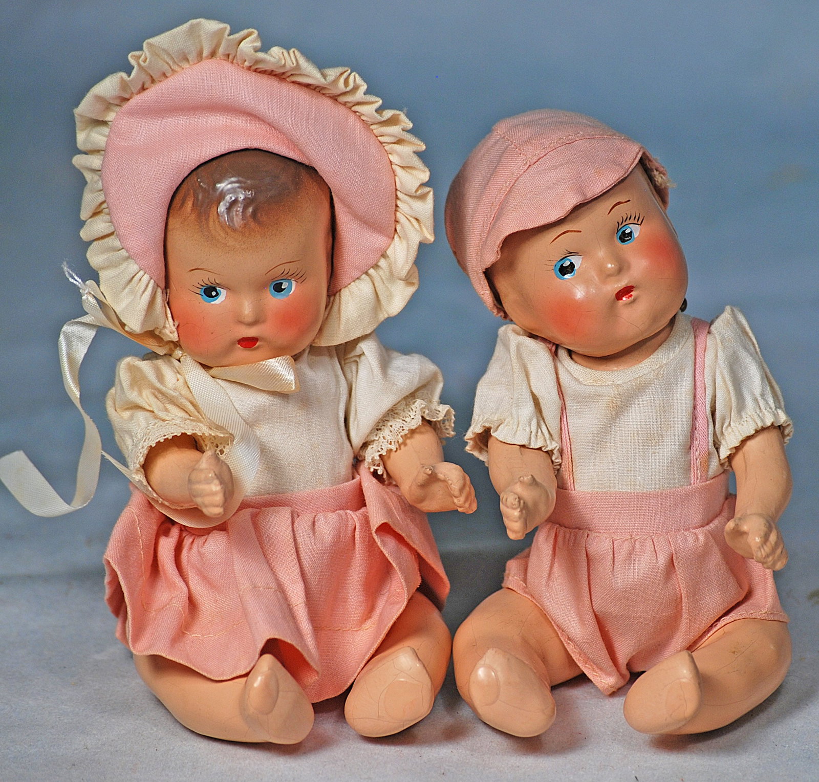 PAIR OF ALL-ORIGINAL COMPOSITION BABIES. 7”. Marks: None. Each is composition socket head: 271. PAIR OF ALL-ORIGINAL COMPOSITION BABIES. 7”. Marks: None. Each is composition socket head with five-piece jointed baby body, painted brown hair, painted features, side-glancing blue eyes,