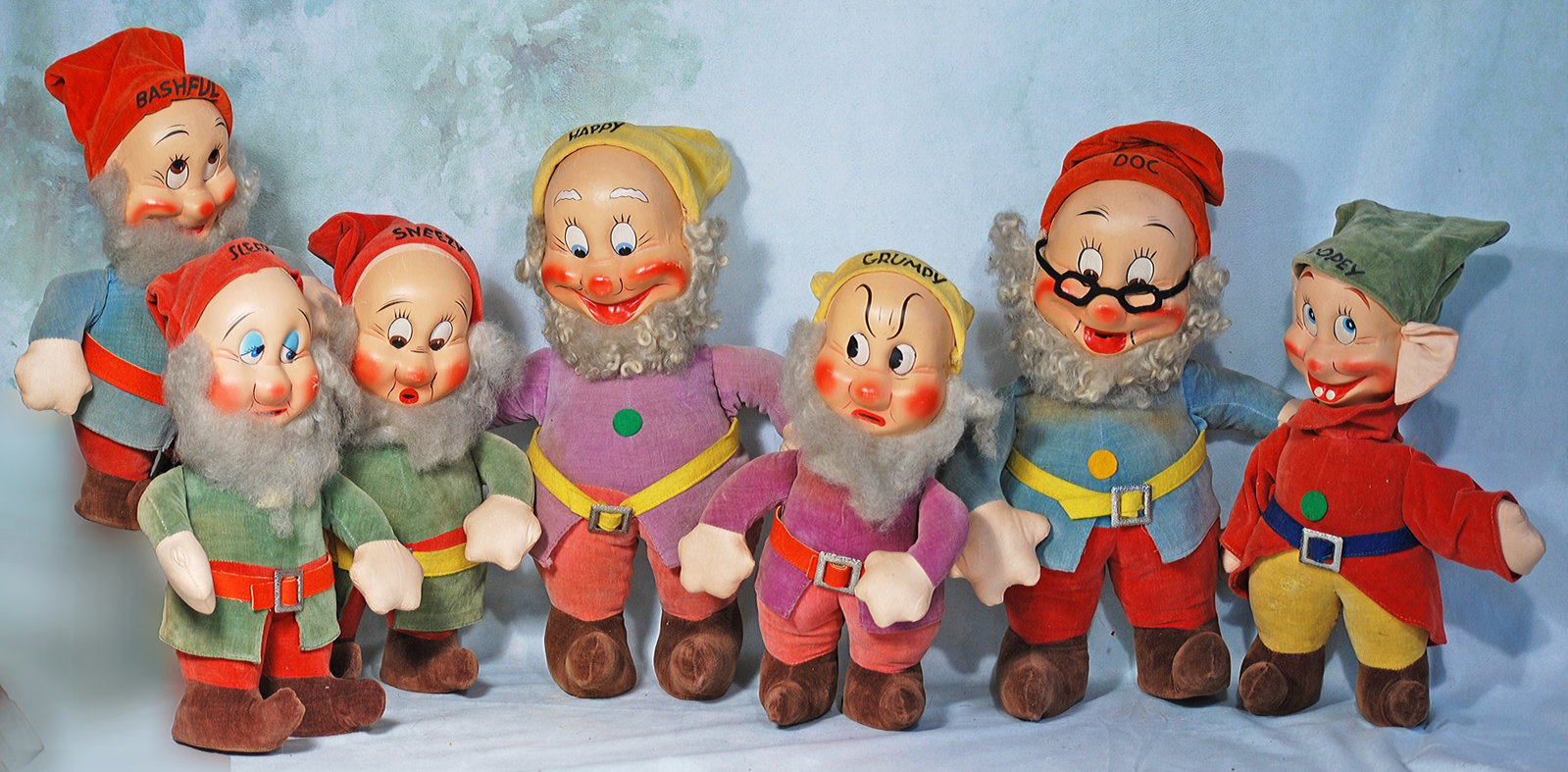 SET OF CLOTH DISNEY SEVEN DWARVES.: 285. SET OF CLOTH DISNEY SEVEN DWARVES. Five are 9’ and two are #12. Each has mask-pressed face with painted features emphasize the unique character of each dwarf, velvet costumes, pointed shoes,