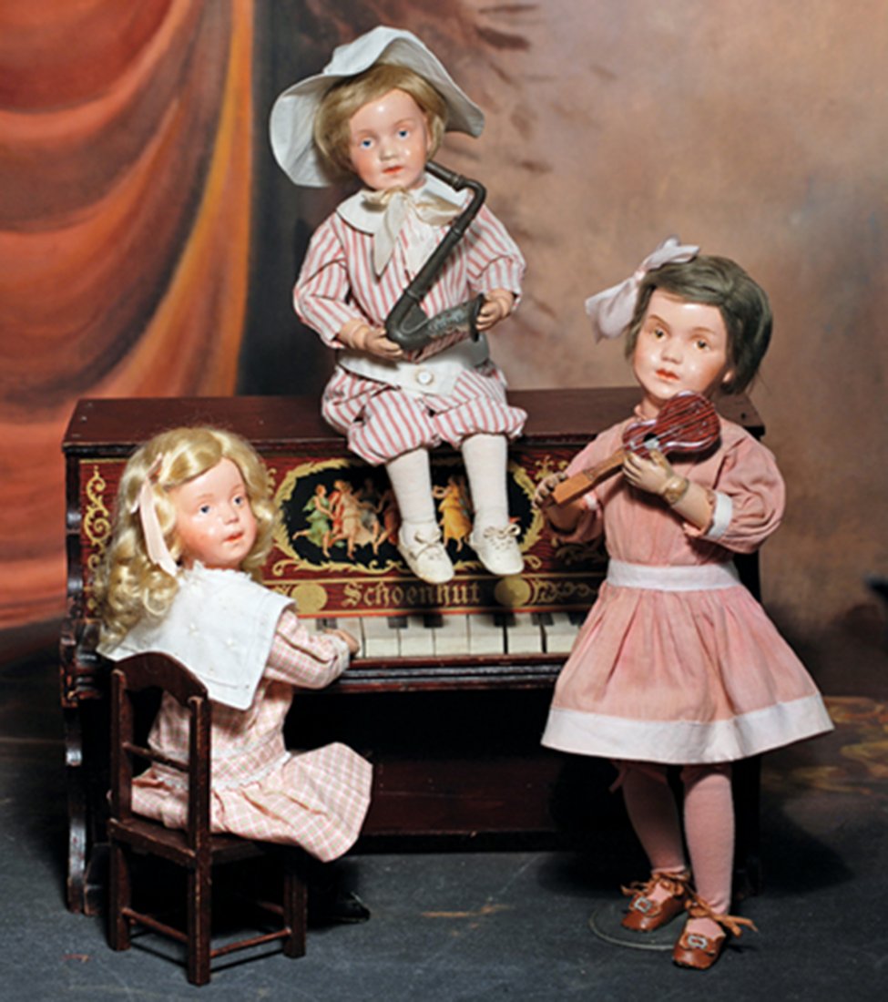 SCHOENHUT WOODEN CHARACTER GIRL IN FACTORY DRESS, MODEL: SCHOENHUT WOODEN CHARACTER GIRL IN FACTORY DRESS, MODEL 311. Marks: Incised Schoenhut mark. 14”. Carved wooden socket head, spring-jointed wooden body, painted features, brown intaglio eyes, upper e