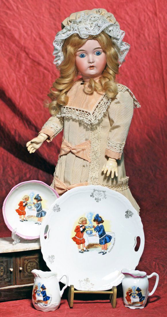 GERMAN PORCELAIN “BUSTER BROWN” CHILDREN’S DISHES.: GERMAN PORCELAIN “BUSTER BROWN” CHILDREN’S DISHES. White china dishes with colorful scenes of Buster Brown characters having tea; includes large 9” diameter plate with decorative gilt detail,
