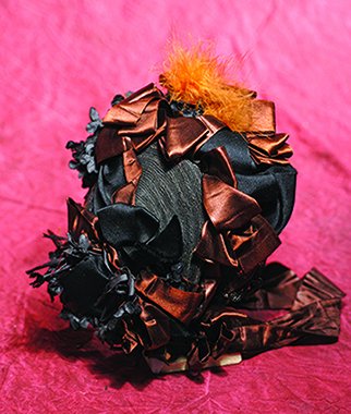 FANCY BLACK WOVEN STRAW BONNET. 4” inside cap width.: FANCY BLACK WOVEN STRAW BONNET. 4” inside cap width. Flat-backed woven straw bonnet with 2 ¼” graduated brim covered in black scalloped-edge lace, abundantly decorated with rich brown silk-satin