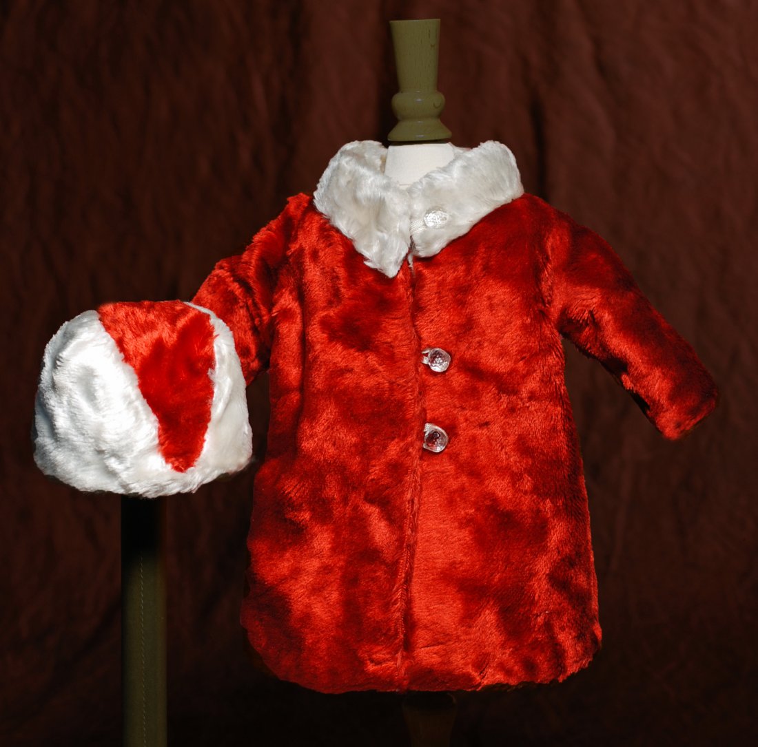 RED FUR COAT AND HAT WITH WHITE FUR TRIM. 5 ¾”: RED FUR COAT AND HAT WITH WHITE FUR TRIM. 5 ¾” shoulder width, 10 ½” length. Cherry red faux fur coat has inset long sleeves, white fur collar, three clear glass round buttons closing the front,