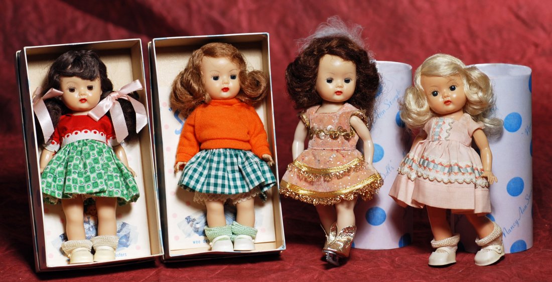 “MUFFIE” BY NANCY ANN STORYBOOK DOLLS. 8”. Hard: “MUFFIE” BY NANCY ANN STORYBOOK DOLLS. 8”. Hard plastic walker with brown sleep eyes, molded and painted lashes, brunette pigtails, tagged red and green cotton print dress, attached slip, cotton