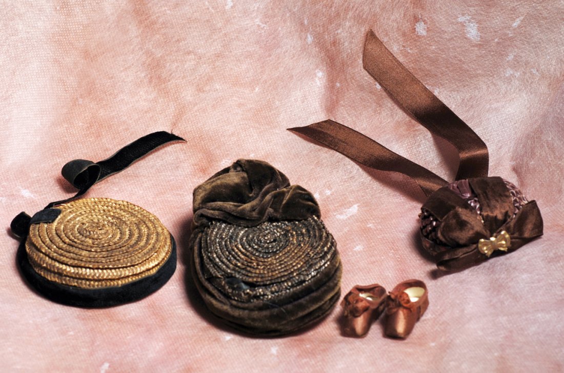 THREE FASHION BONNETS AND PAIR OF FASHION SLIPPERS.: THREE FASHION BONNETS AND PAIR OF FASHION SLIPPERS. Includes: (1) Flat woven natural straw bonnet with black velvet ribbon band, 2 ¾” inside cap width; (2) Brown woven straw bonnet with flat back,